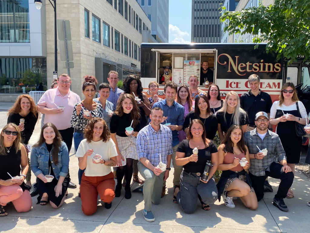 A group of ITX team members enjoying an ice cream during a nice summer day outside of ITX headquarters, at Downtown Rochester